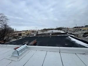 Commercial flat roof with membrane roofing system and skylight curbing installation