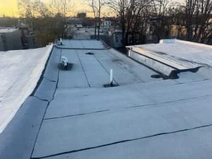 Flat roof with membrane system, roof vents, and equipment penetrations