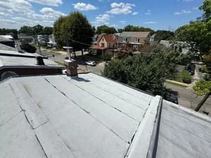 White membrane flat roof with seams and flashing on commercial building