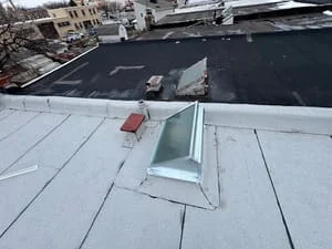 White membrane flat roof with installed skylight curb on commercial building