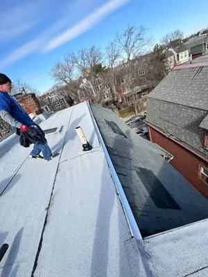 Gray asphalt shingle roof installation with flashing and clean edges on residential home