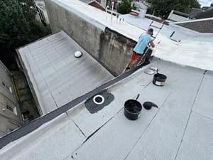 Flat roof with light membrane, seams, and drainage penetrations during installation