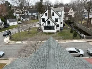 Aerial view of residential home with newly installed gray asphalt shingle roof