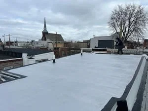 White flat roof membrane with metal edge trim on commercial building